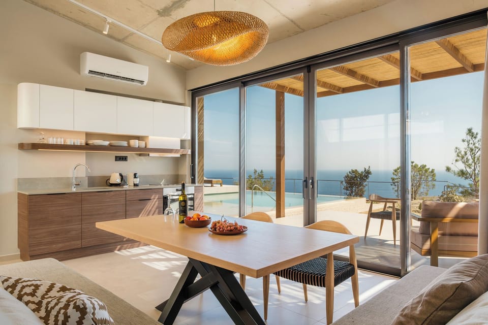 The living room features a 32” Smart TV, a corner sofa, accompanied by a dining table, and a variety of board and card games.
