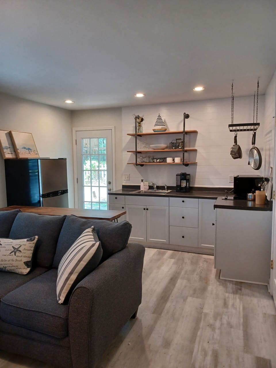 Open Concept Living Room to kitchen. Bathroom door is on the right side.