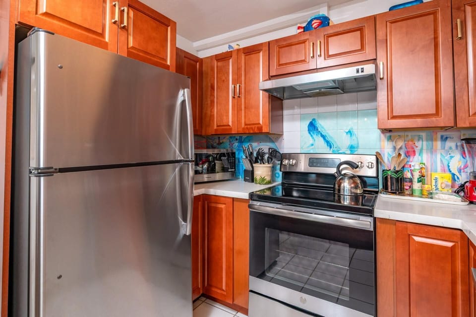 Modern stainless appliances and bold backsplash bring color and function. MAH-1219