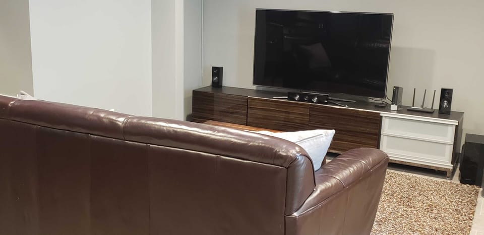 comfy leather couch with modern furniture, Samsung 55 in. SmartTV with Roku