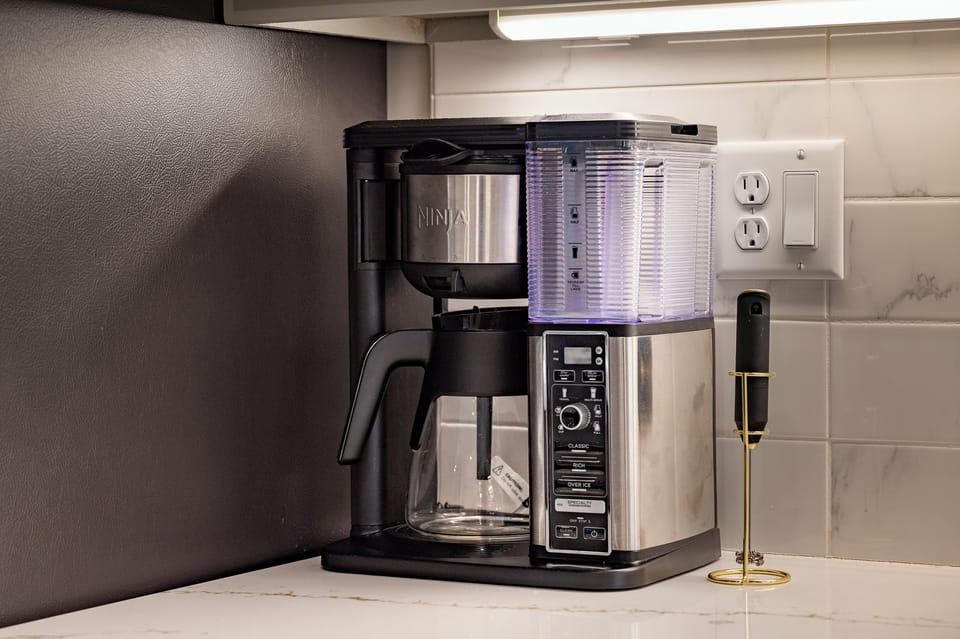 - Start your mornings strong with a fully equipped coffee station featuring a sleek brew system - Whether you love drip or specialty drinks, everything you need is right here - Conveniently located on the counter for easy access and bold flavor