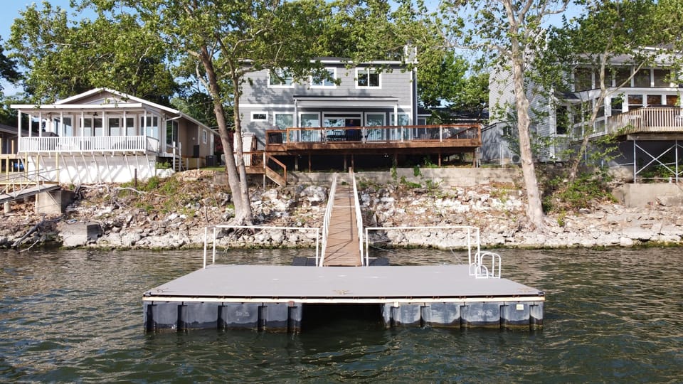 Lakeview of dock, outdoor deck and back of house