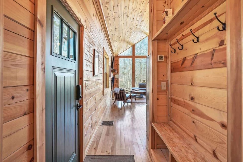 Entrance Hallway: Step into nature with this stunning entryway bathed in sunlight and warm wood!