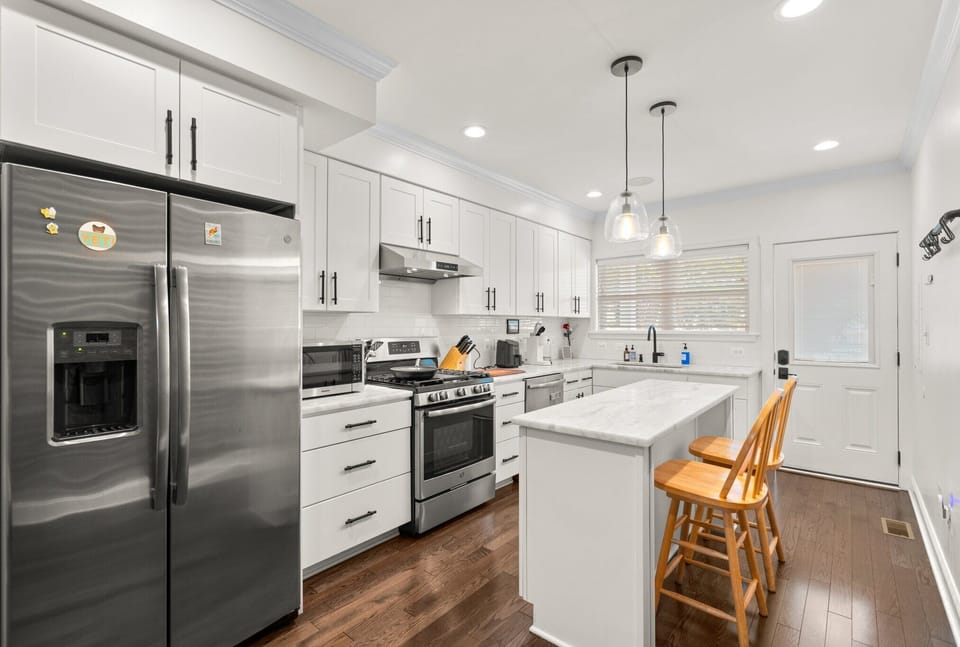 Another view of kitchen with high end appliances. Fridge has clean water filter.