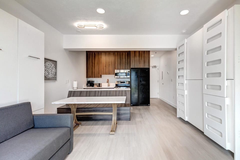   Sleek modern kitchen with cozy seating and clever storage solutions throughout.