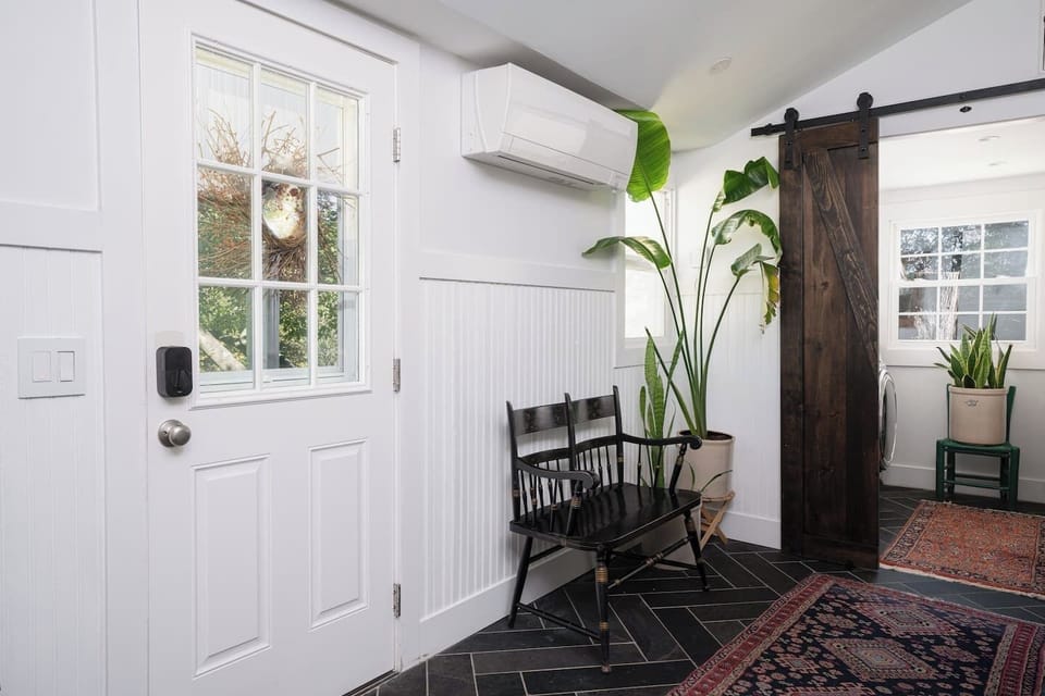 A modern mud-room / drop-zone greets guests.