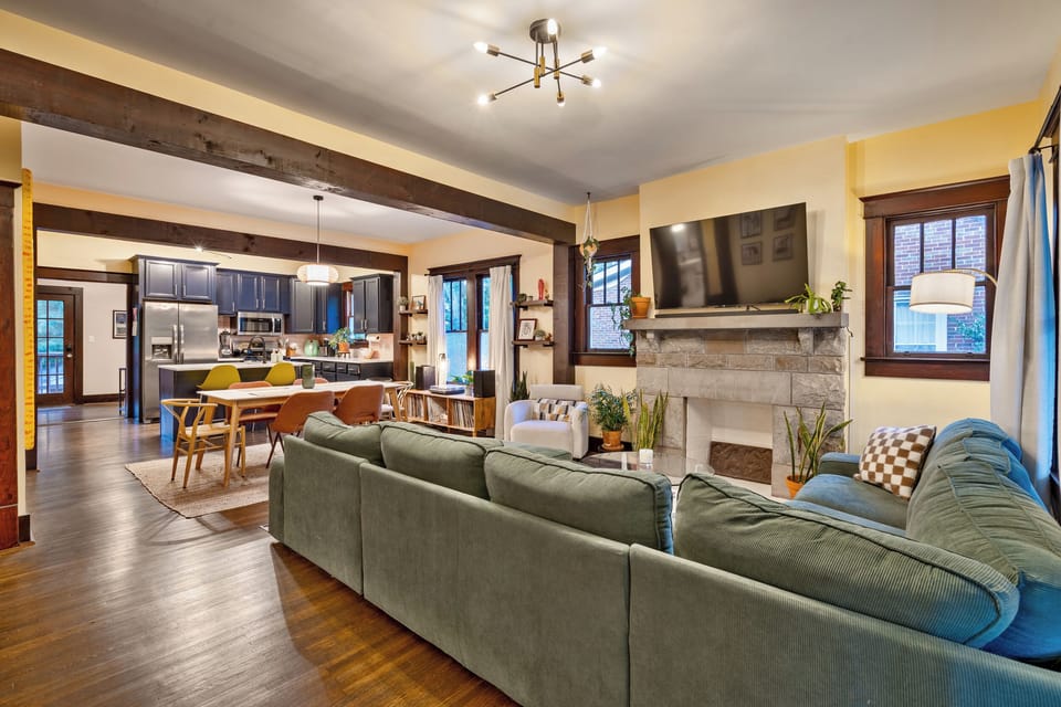 large open concept living space with 60 inch smart TV and large sectional