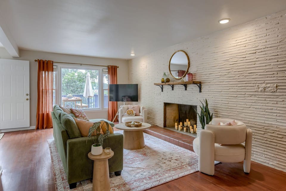 Living room with fire place, cozy couches, and TV