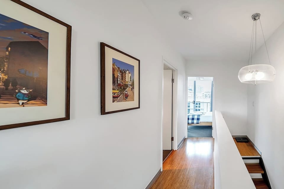This apartment is staged over two levels, with the bedrooms encompassing the upper floor.
