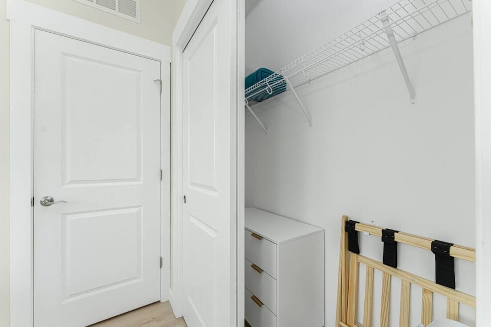 Primary Bedroom with Built In Closet, Dresser, Luggage Rack, Hangers, Robe and Extra Blanket