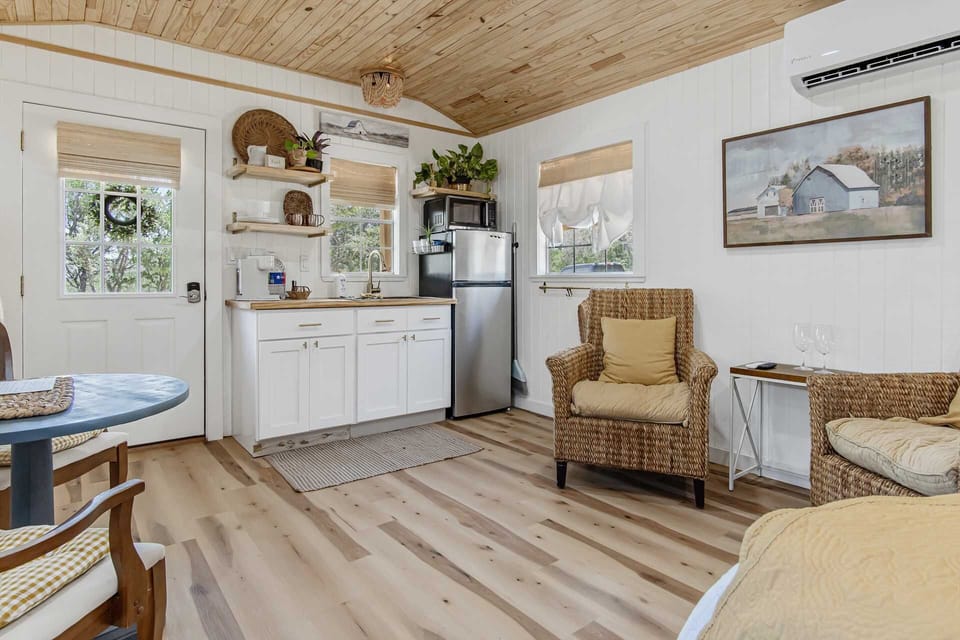 Your cozy kitchenette includes a fridge, a microwave that also serves as a conventional oven, a Keurig coffee maker, and essential dining ware.