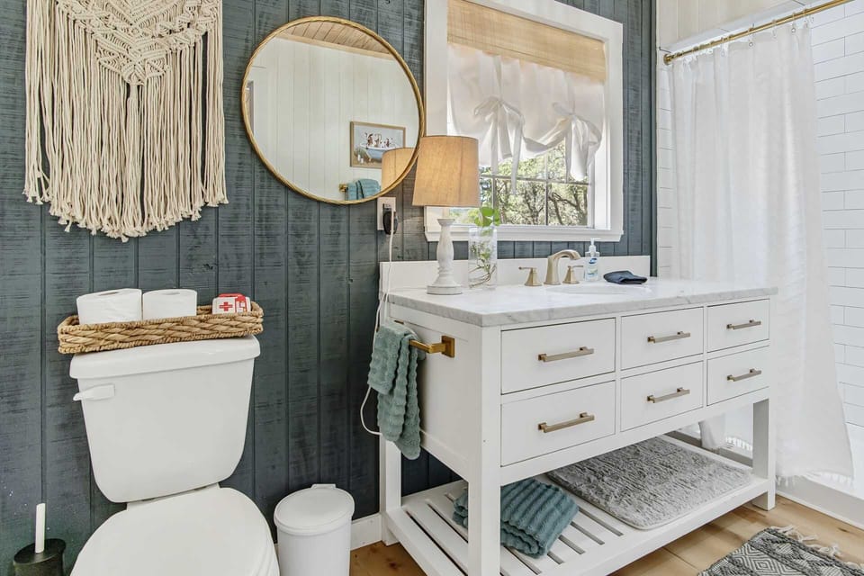 Alongside a charming vanity, you'll find a spacious shower, fresh linens, and basic toiletries in the cabin's full bath.