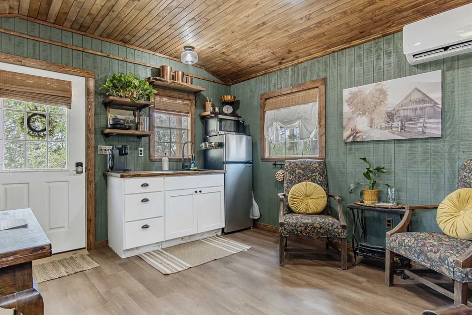 Tasteful country decor surrounds the cozy kitchenette, equipped with a fridge, microwave, and Keurig coffee maker!