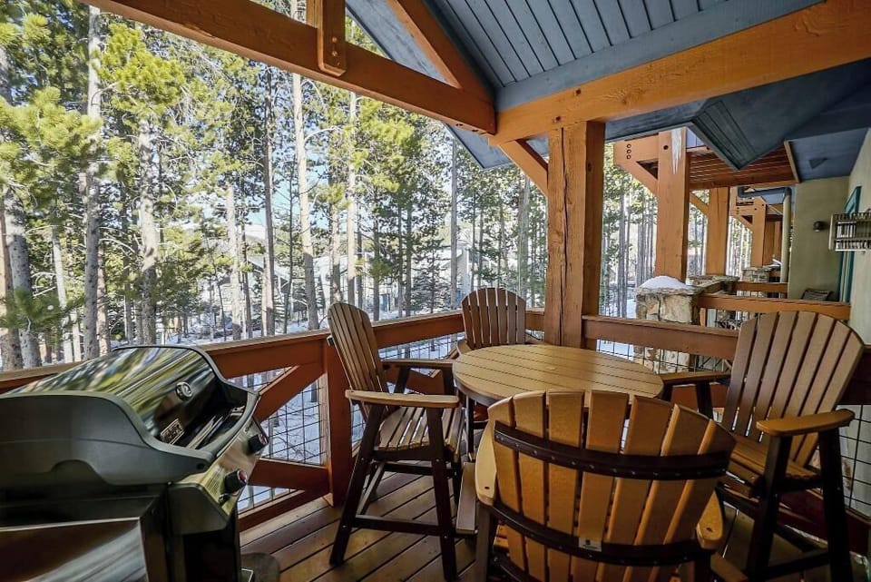 Patio off living room with grill and gorgeous forest views