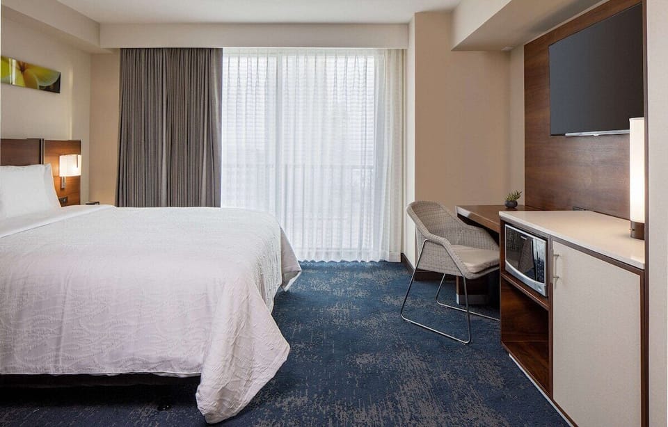 Stretch out in a serene king room with workspace nearby.
