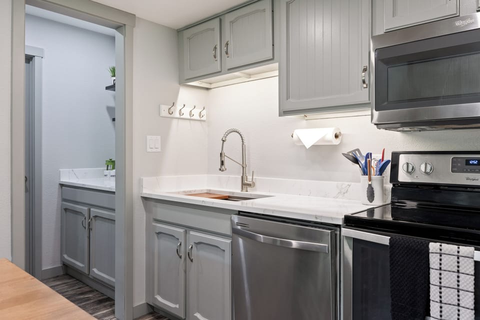 Well-equipped kitchen featuring stainless steel appliances, generous counter space, and modern cabinetry—ideal for preparing meals during your stay.