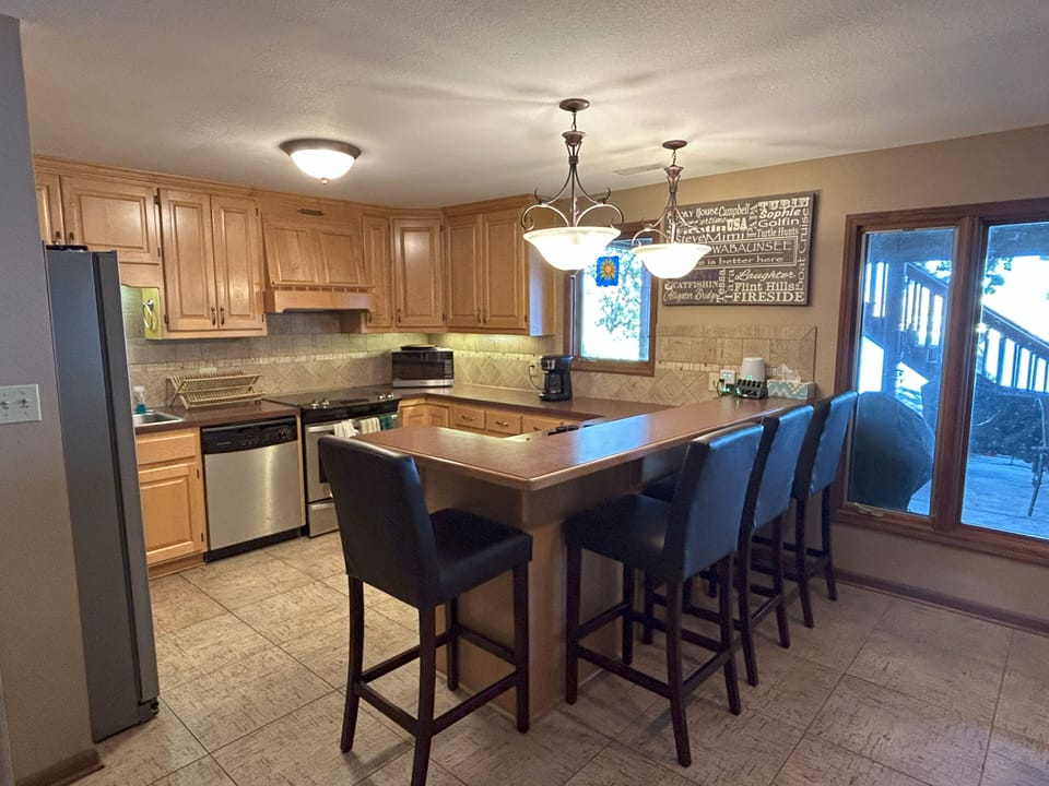Full kitchen with all appliances and bar-style seating for 4.