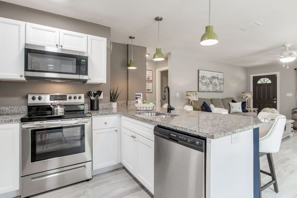 Enjoy effortless cooking in this modern kitchen with stainless appliances and all the tools you need.