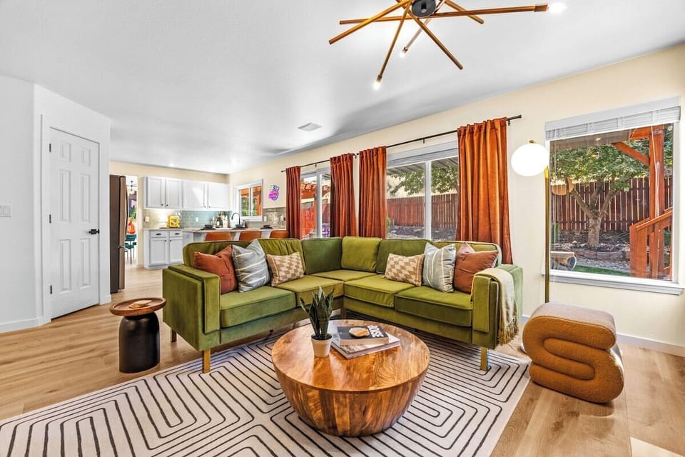 The main living area right off the kitchen with direct access to the backyard. The spacious couch can seat all your guests!