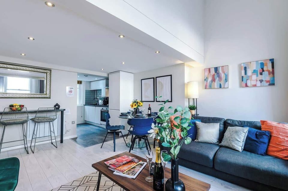 The open-plan living room and dining area benefit from a 50-inch Smart TV, a 4-seater dining table,  a 3-seater breakfast bar, plenty of space to sit down in the evenings and a double sofa bed.