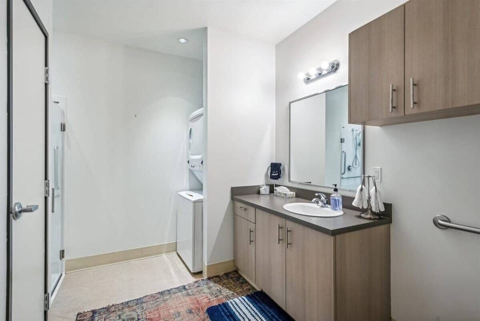 Spacious and bright bathroom with a clean, modern feel. Includes washer and dryer and plenty of storage.