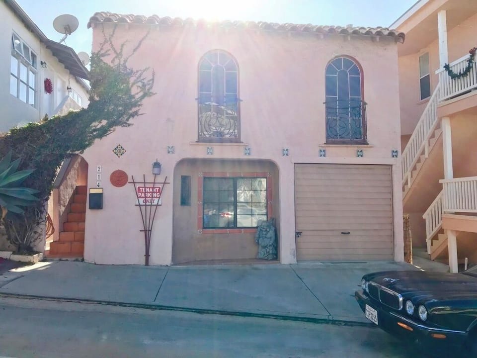 Front of the house. 214 front door is thru the arch entryway. 212 front door is in the back of the house.