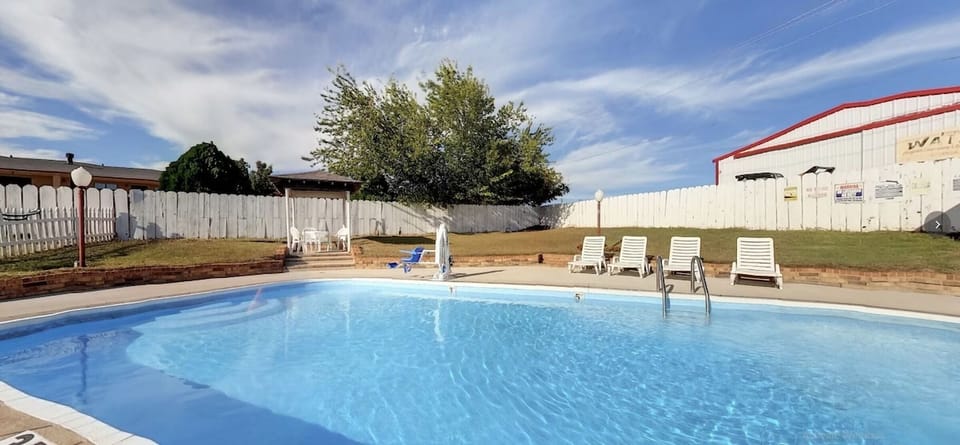 Soak up the sun beside a sparkling pool and loungers.