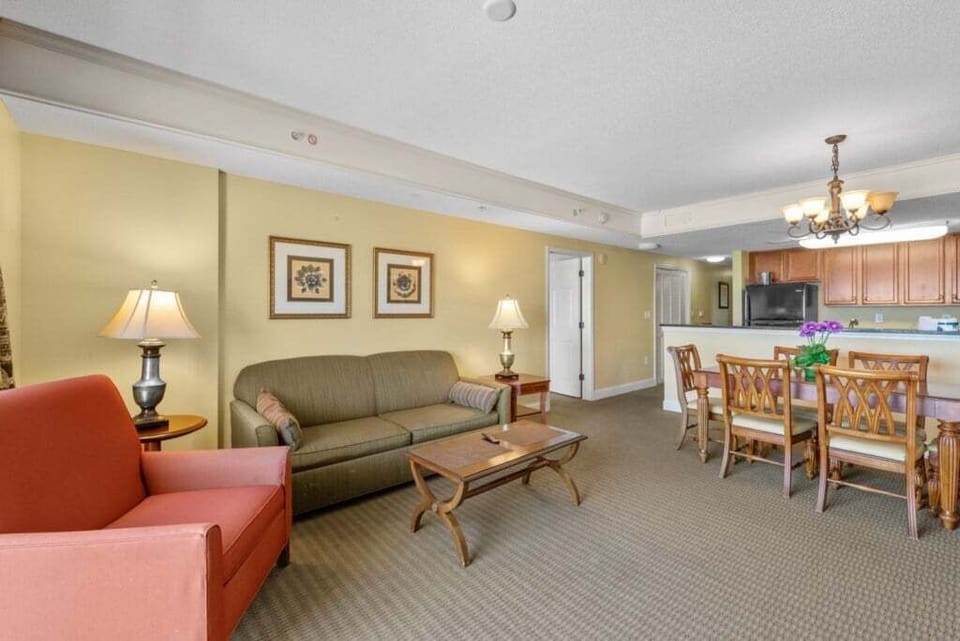 Living Room - Bright living area with comfortable seating and flat‑screen TV — an inviting space to unwind after a day at the beach.