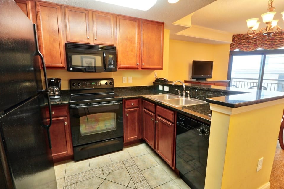 Kitchen - Full kitchen with refrigerator, stovetop, dishwasher, microwave, coffee maker, and toaster — everything you need to prepare meals at your vacation home.