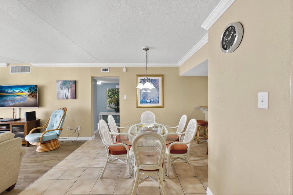 Dining Area - Dining table located beside the living area and kitchen, providing space for meals or gathering together.
