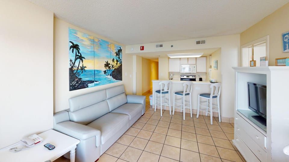 Living Room - Relax in the comfortable living space with three flat-screen TVs — perfect for movie nights with family or friends.