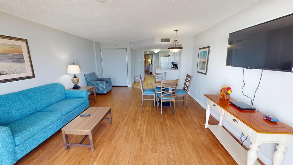 Living Room - Relax in the inviting living area equipped with two flat-screen TVs — perfect for movie nights after the beach.