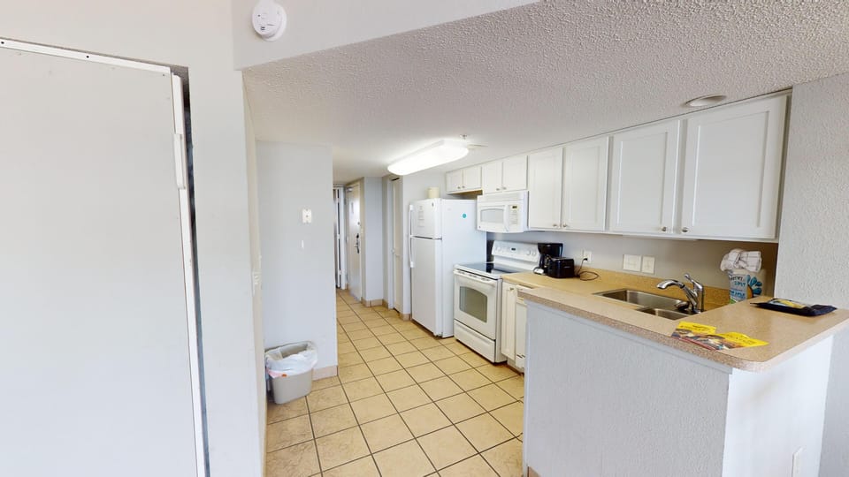 Kitchen - Whip up snacks or full meals in the fully equipped kitchen with stove, oven, refrigerator, dishwasher, and cookware.