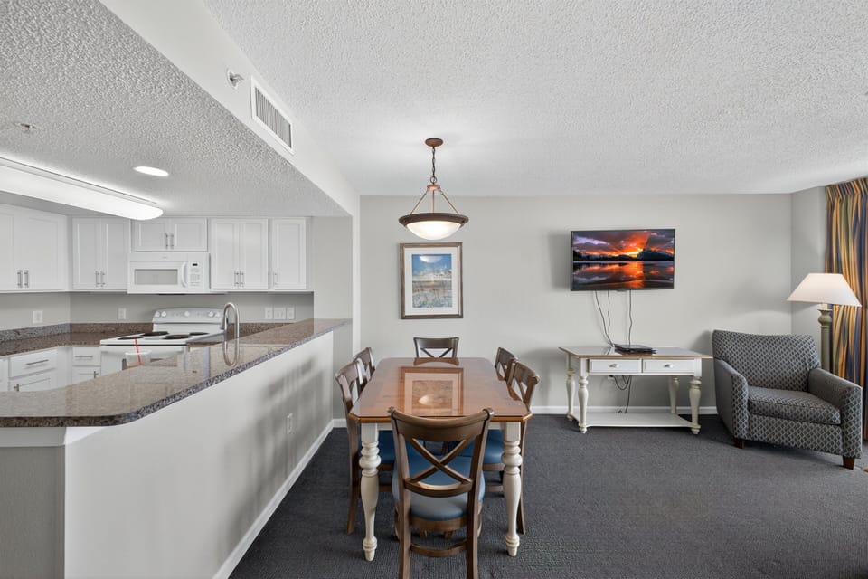 Dining Area - Gather around the dining area for family meals or game nights after a day at the beach.