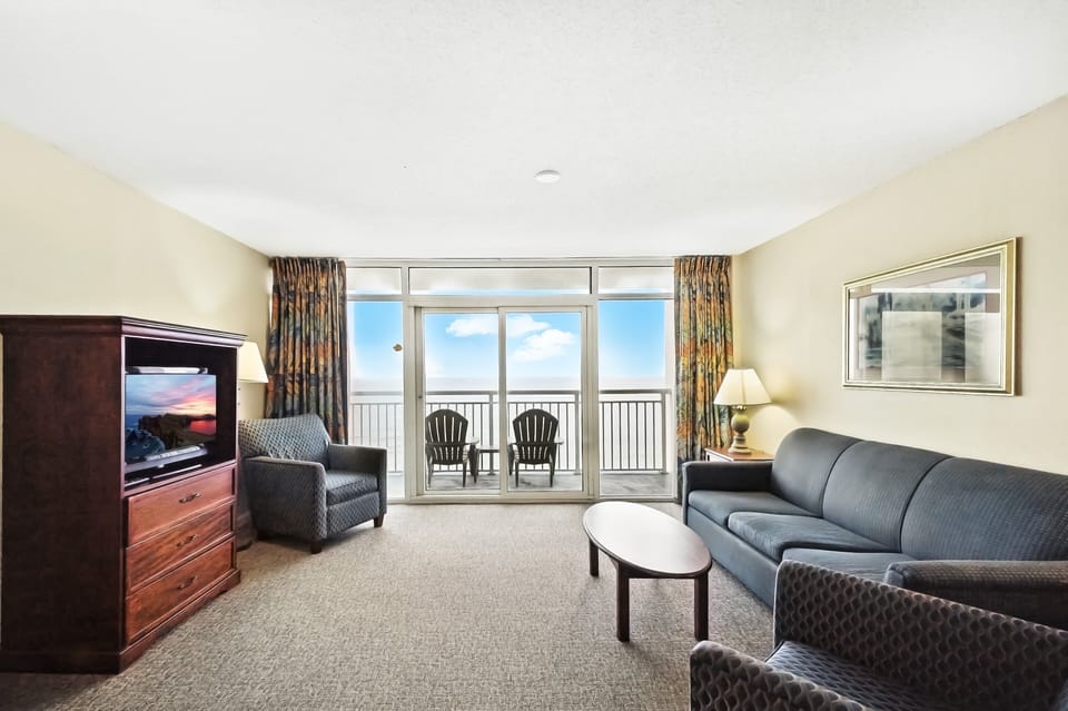 Living Room - Relax in the inviting living area with plenty of seating and dual flat-panel TVs — ideal for family downtime