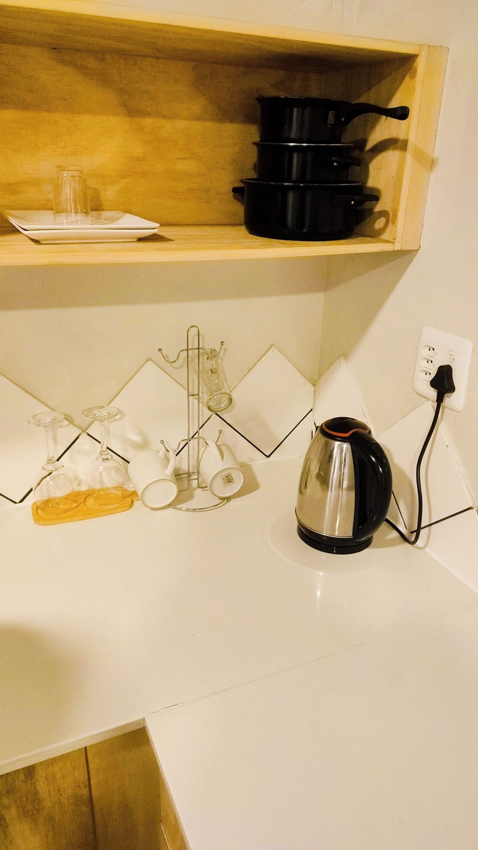 Kitchen with stove,cups and pots to cook from