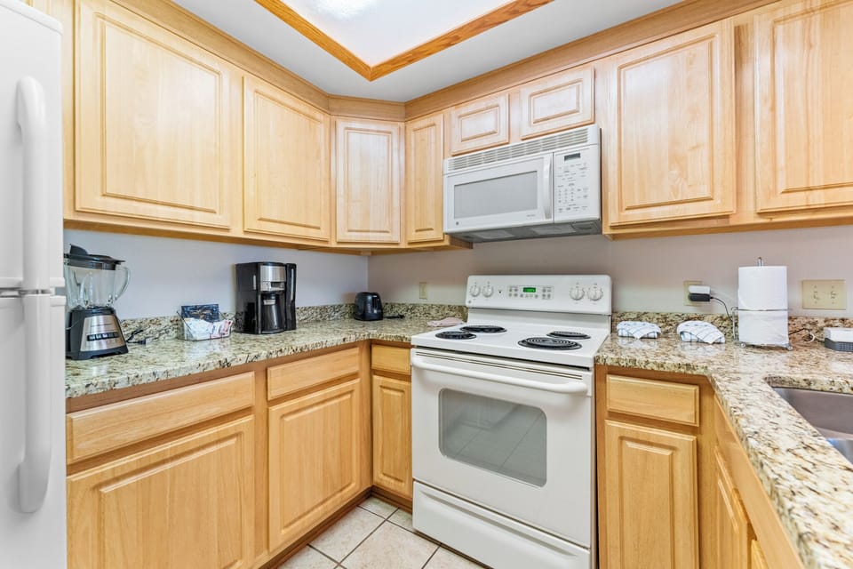 Your fully-equipped kitchen features granite counters, oak cabinets, and everything needed to create memorable meals during your stay.