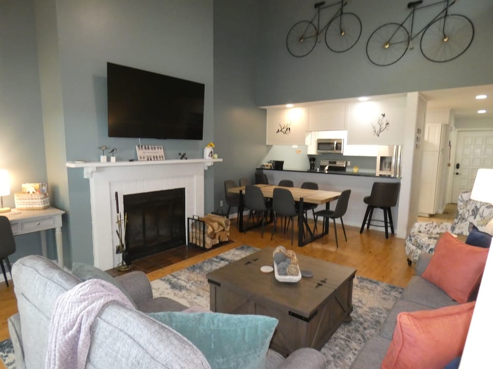 Big Living room with wood fireplace and big screen tv.