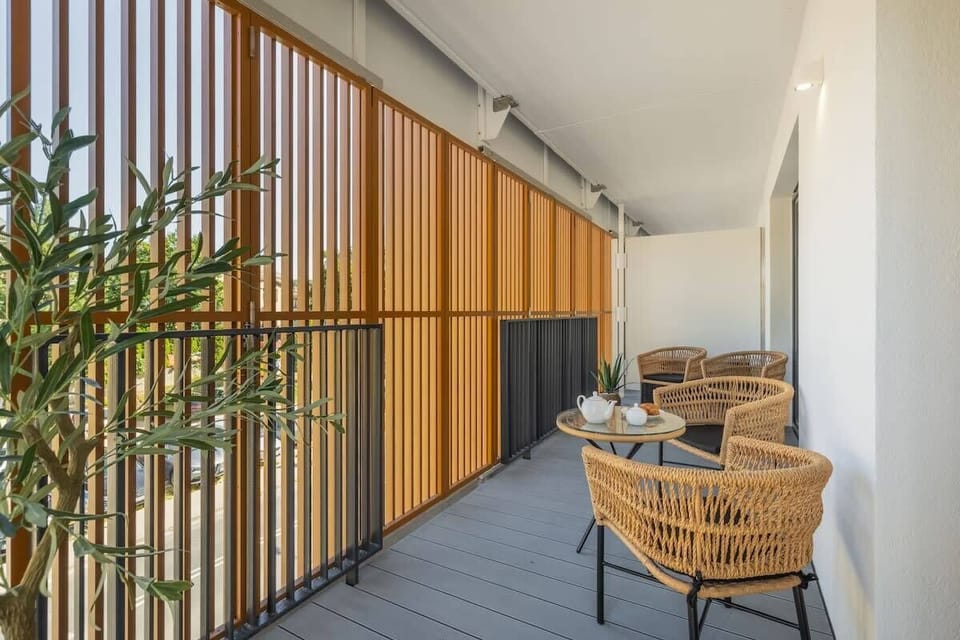 Another angle of the same balcony with plants and wooden paneling.