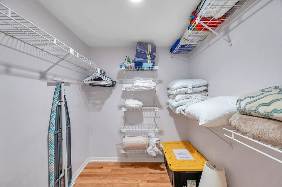 Organized storage closet w/ shelving to keep beach gear neatly tucked away.