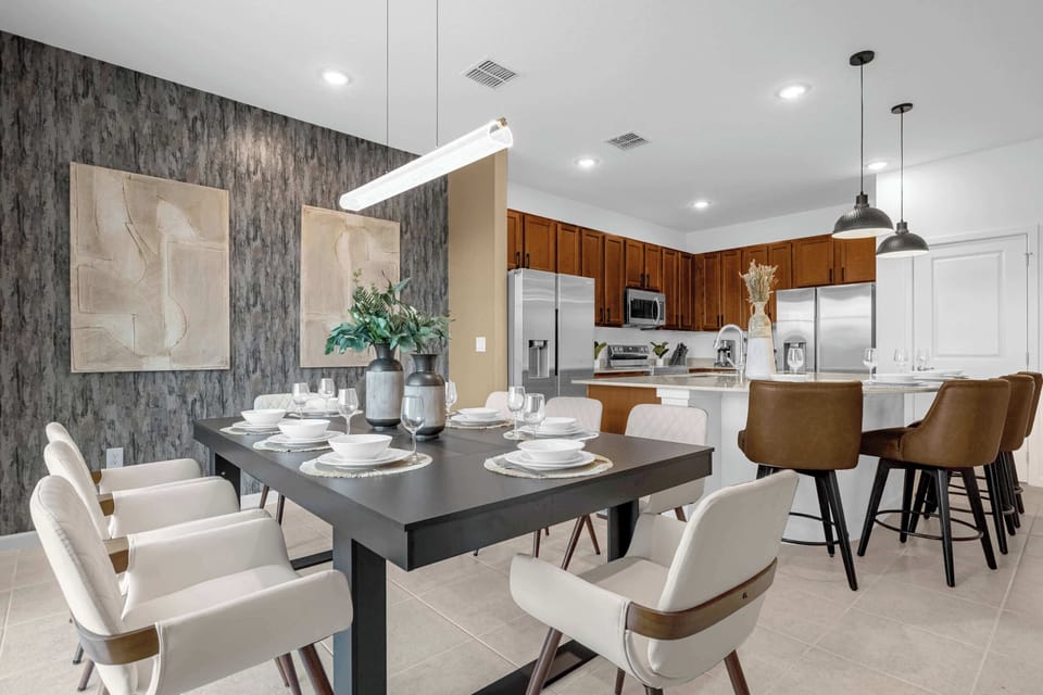 Stylish Dining Table Set For Eight, Overlooking The Spacious Open-Concept Kitchen