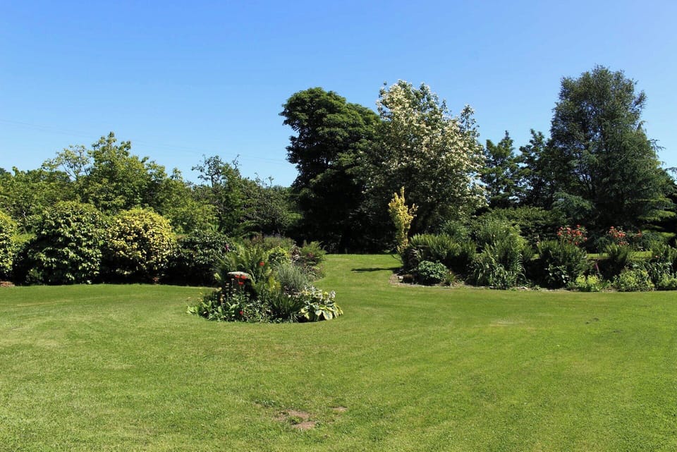 Expansive 2 acre gardens. 