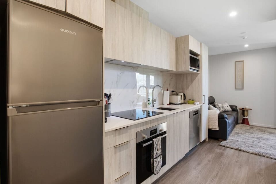 The kitchen has a cook top, oven, dishwasher, microwave and fridge/freezer.