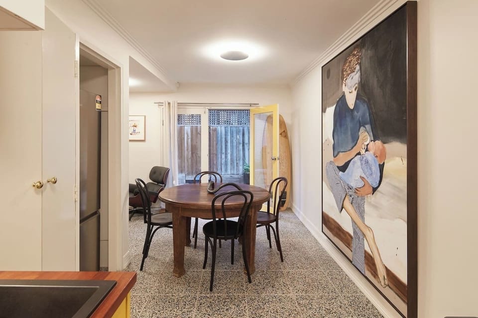 Artworks surround you as you wine and dine at this stylish deep timber table in the dining area. 