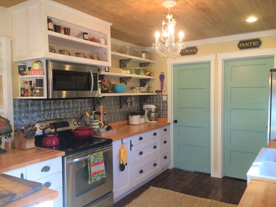 Microwave, stove. Refrigerator and pantry to right.