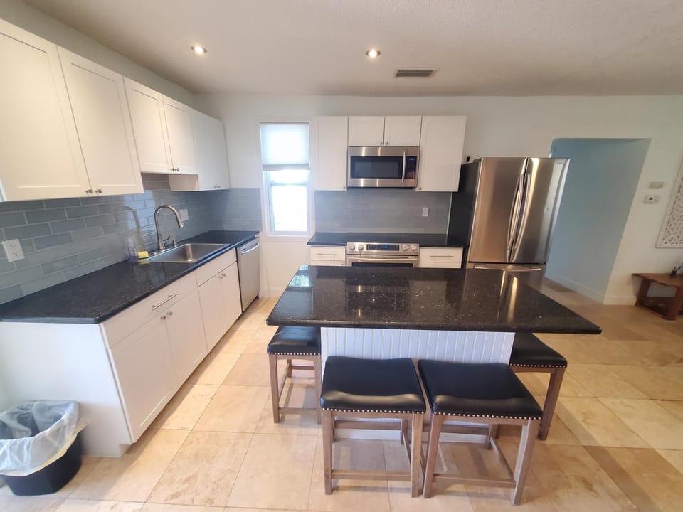Modern kitchen with granite countertops and stainless steel appliances.