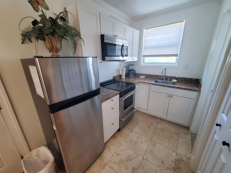 Fully-equipped kitchen with modern appliances and granite countertops.