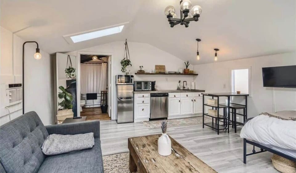 Spacious and bright studio with a well-equipped kitchen, cozy seating area, and modern amenities for a comfortable stay.