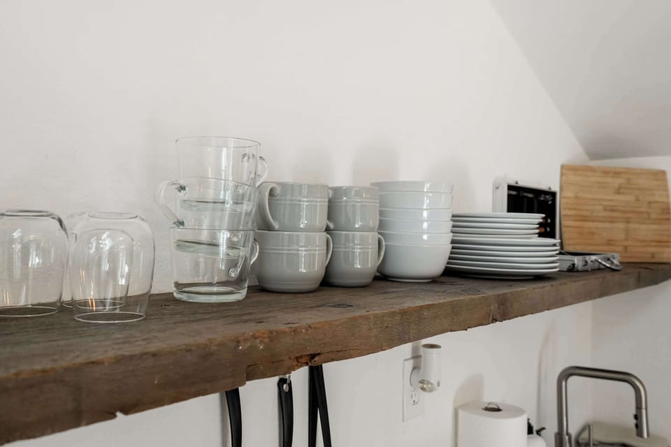 Enjoy the convenience of a well-stocked kitchen with all the essentials, from glassware to dinnerware, ready for your culinary creations.