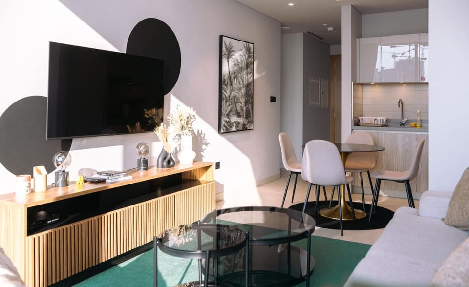 Unwind in the cozy living room, where a plush sofa faces a large TV, ideal for movie nights or catching up on your favorite series.